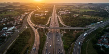 Vista aérea de uma rodovia moderna e uma ferrovia cruzando em um cenário brasileiro, simbolizando o avanço da infraestrutura.